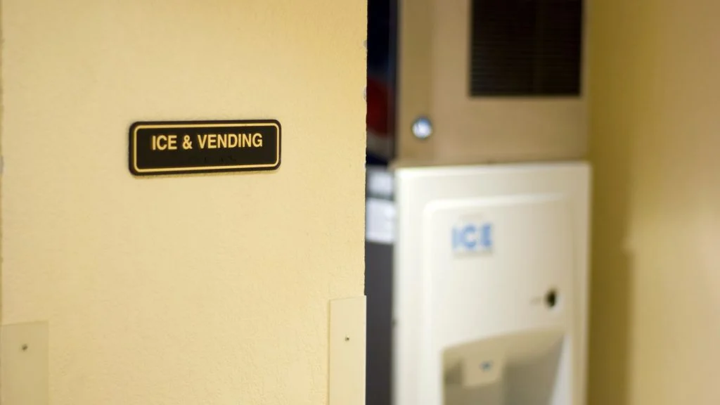 Staff performing regular maintenance on industrial ice maker